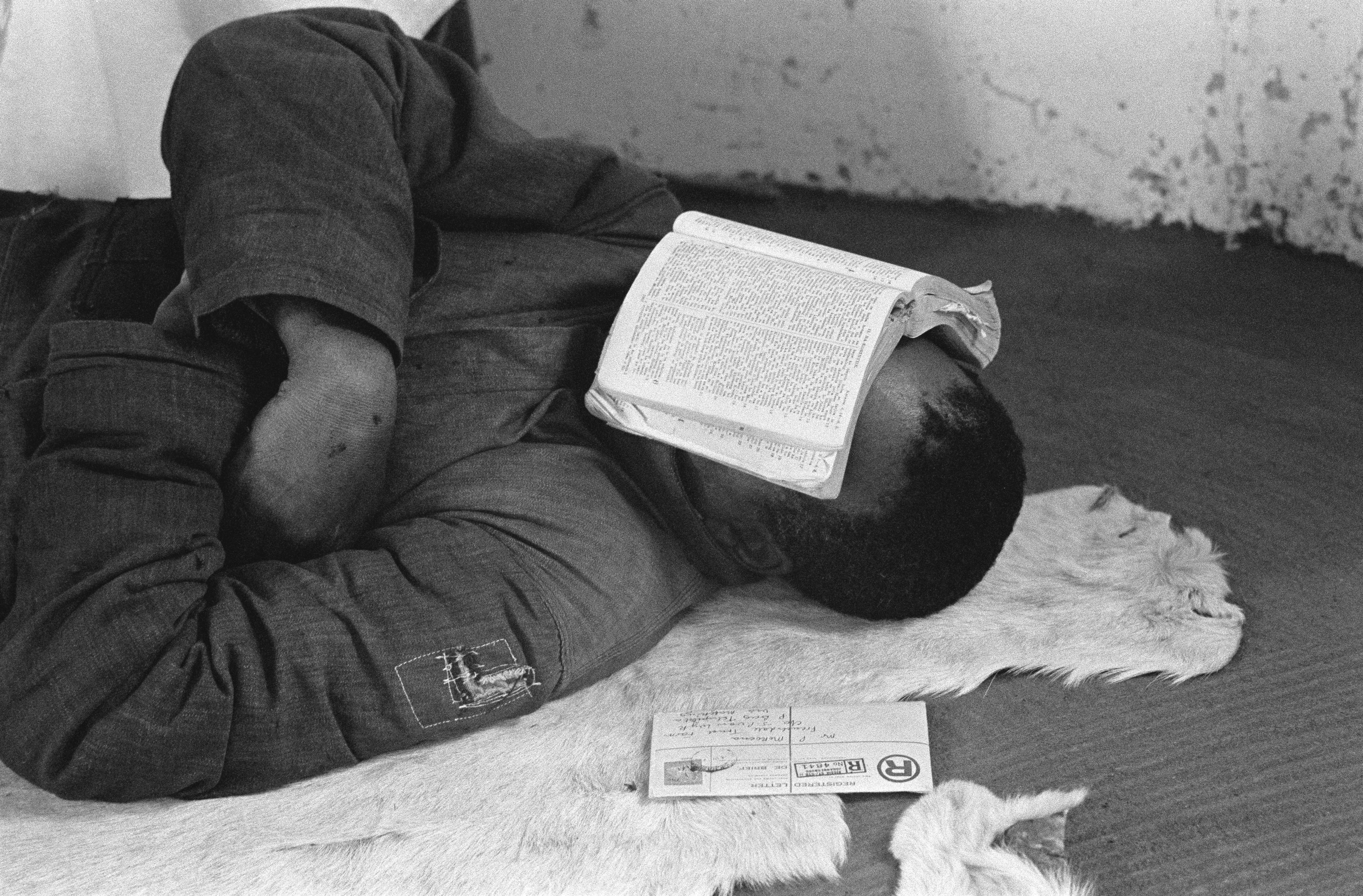 men sleeping with bible book on his face